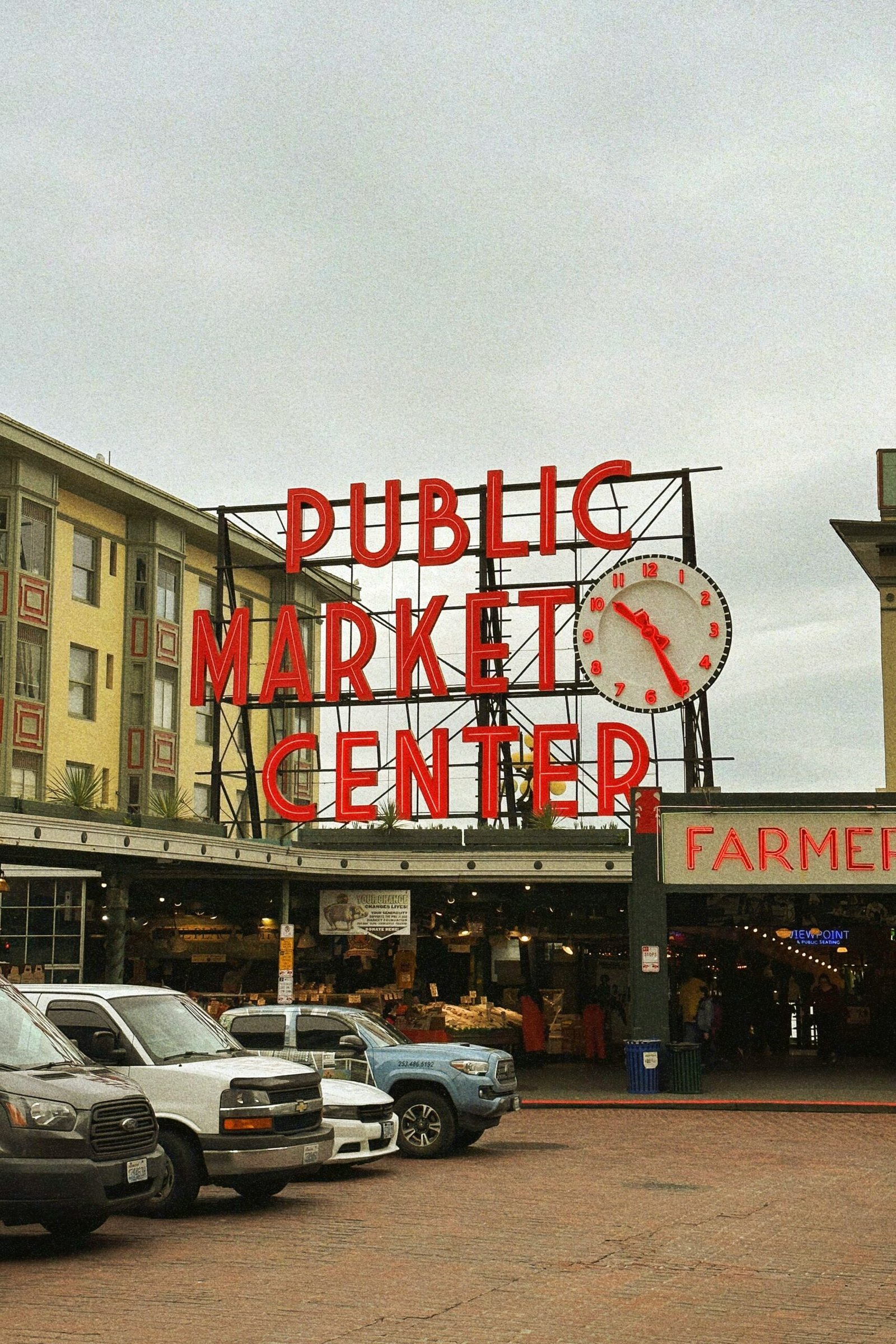 a public market center with cars parked in front of it